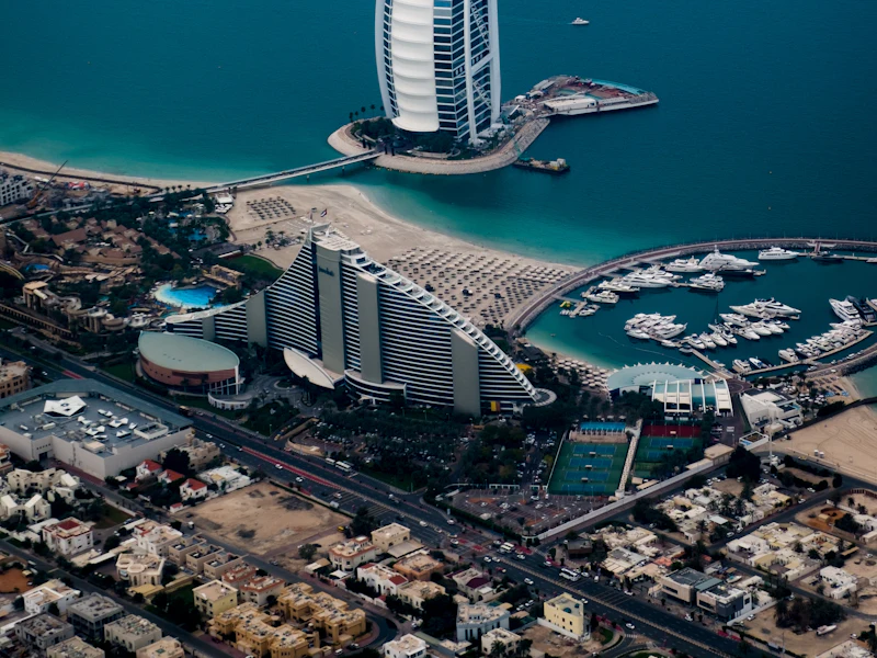 Aerial view of the Dubai coastline showing Burj Al Arab and Palm Jumeirah, areas served by Fast Movers UAE